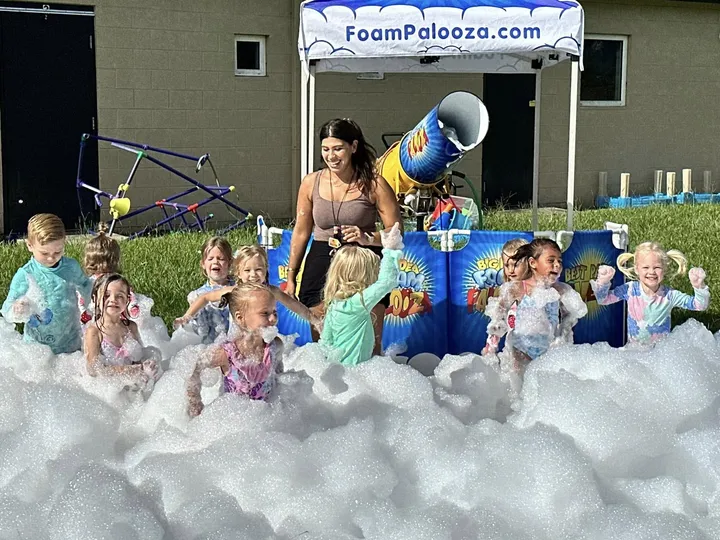 A neighborhood foam party beside an event tent